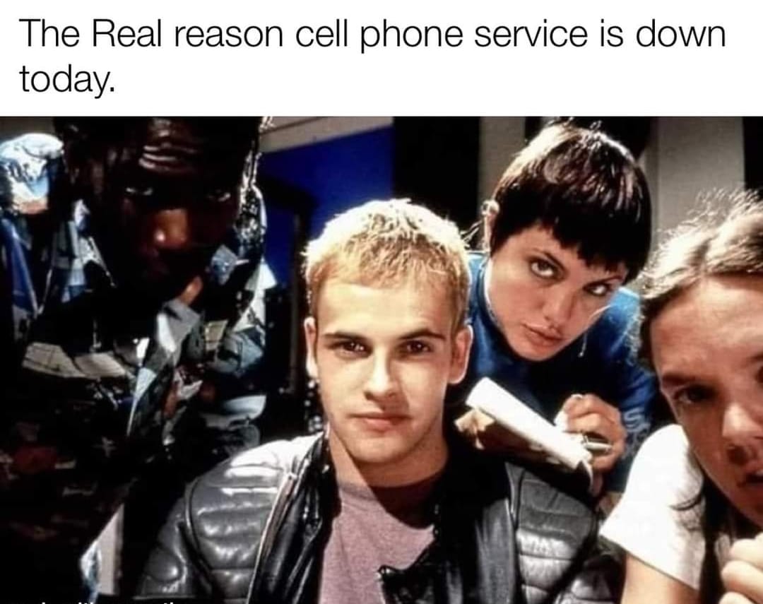 This meme is a humorous take on a common internet phenomenon. The image is a screenshot from the 1999 film "The Matrix" featuring a group of characters looking concerned and confused. The text at the top reads, "The Real reason cell phone service is down today."